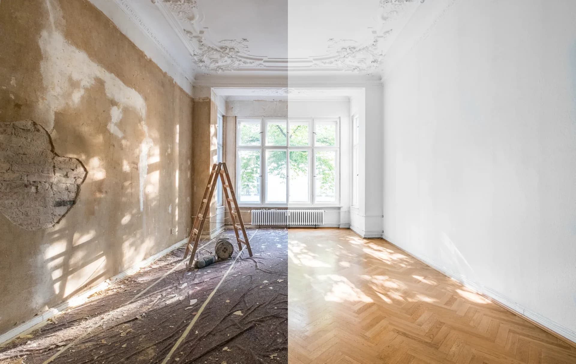 A room mid-renovation: stripped plaster and subfloor on one side, finished parquet and paint on the other